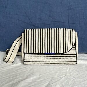 Rothy’s belt bag in tan with black stripes.